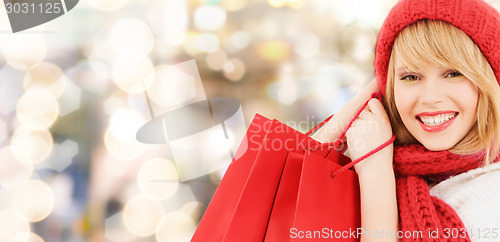 Image of smiling young woman with shopping bags