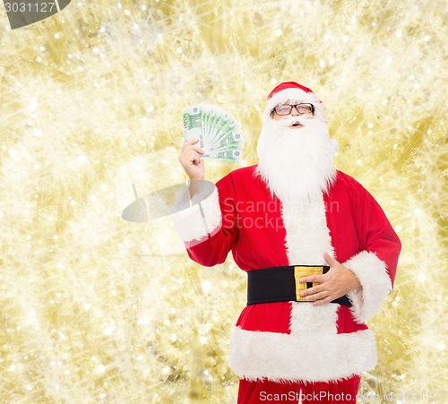 Image of man in costume of santa claus with euro money