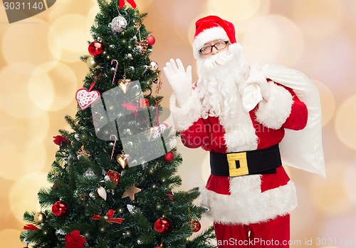 Image of santa claus with bag and christmas tree