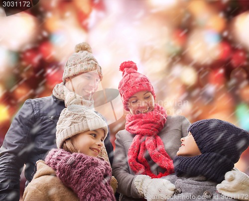 Image of happy family in winter clothes outdoors