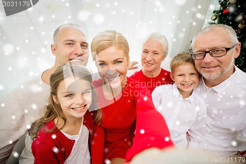 Image of smiling family making selfie at home