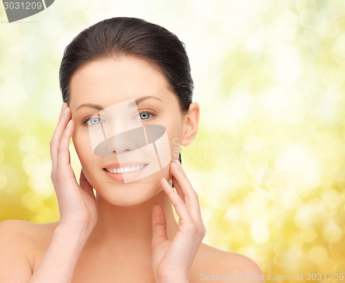 Image of beautiful young woman over yellow background