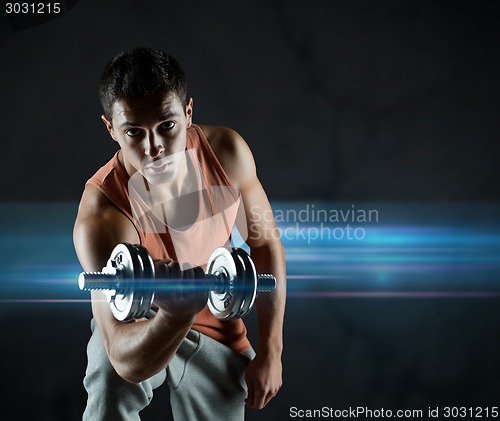 Image of young man with dumbbell flexing biceps