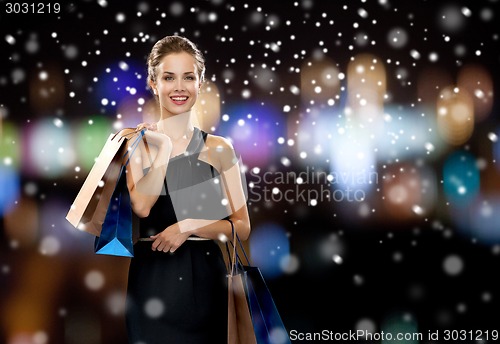Image of smiling woman in dress with shopping bags