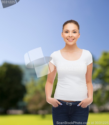 Image of smiling young woman in blank white t-shirt