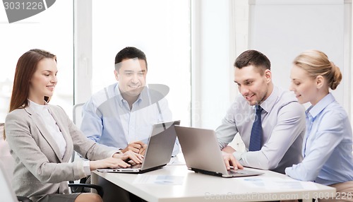 Image of business team working with laptop in office