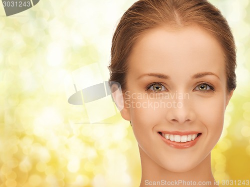 Image of beautiful young woman over yellow background