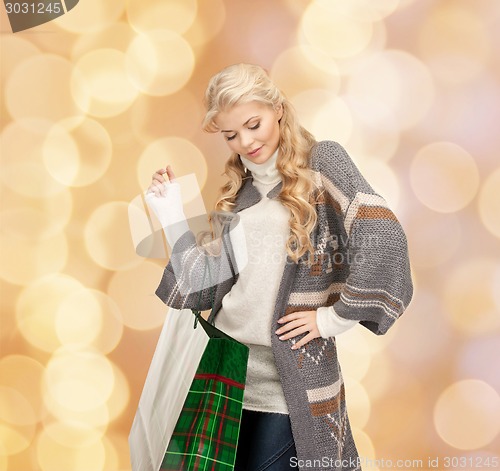 Image of smiling young woman with shopping bags