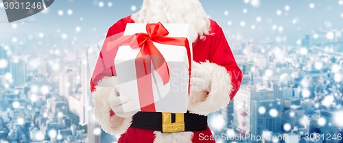 Image of man in costume of santa claus with gift box