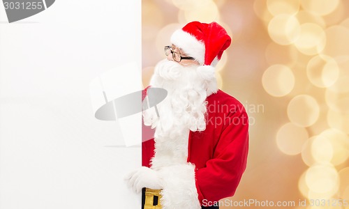 Image of man in costume of santa claus with billboard