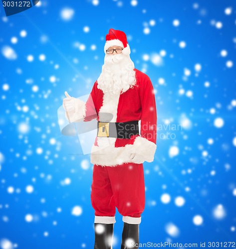 Image of man in costume of santa claus showing thumbs up