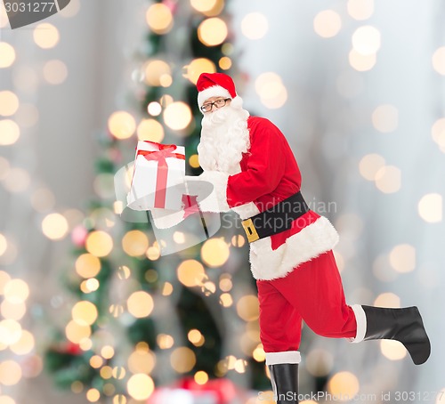 Image of man in costume of santa claus with gift box