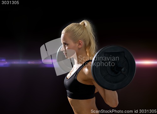 Image of sporty woman exercising with barbell