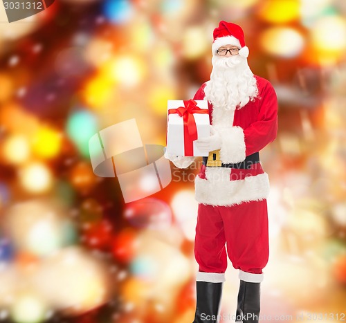 Image of man in costume of santa claus with gift box