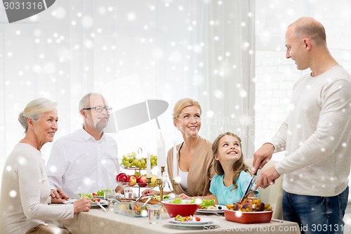 Image of smiling family having holiday dinner at home