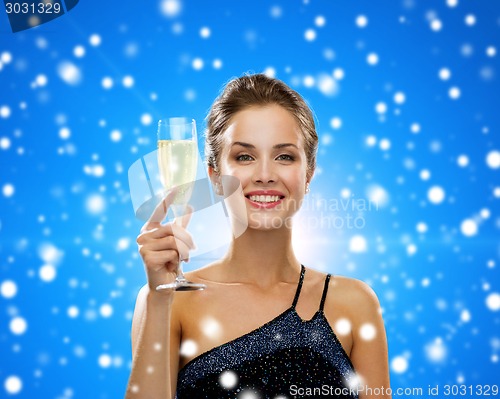 Image of smiling woman holding glass of sparkling wine