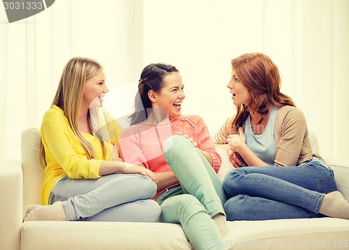 Image of three girlfriends having a talk at home