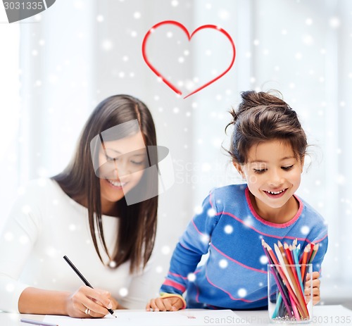 Image of mother and daughter with coloring pencils indoors