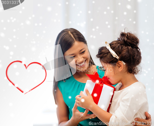 Image of happy mother and child girl with gift box