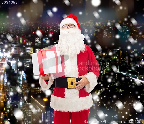 Image of man in costume of santa claus with gift box
