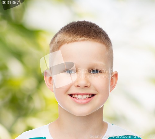 Image of smiling little boy over green background