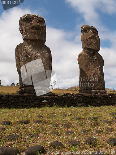 Image of Pair Of Moai Against Blue Sky