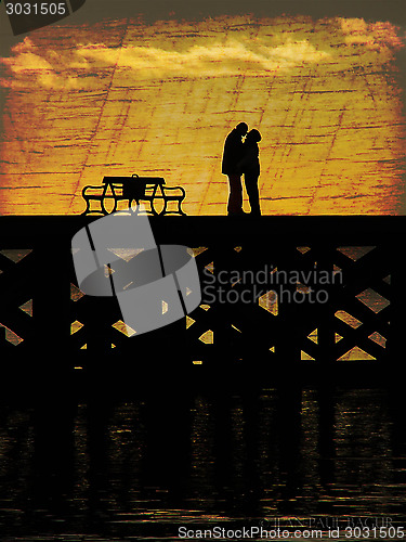 Image of Kissing Couple Silhouette On A Pier