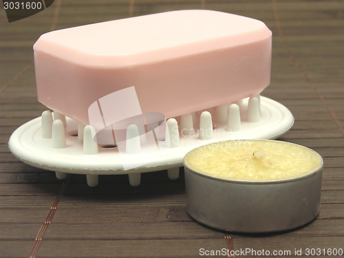 Image of Pink soap with tea light on a  brown background