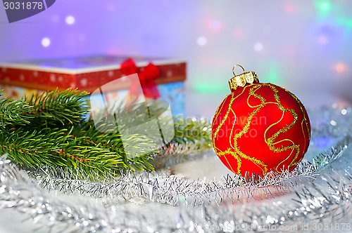 Image of Red Christmas ball, fir branch and with gift box