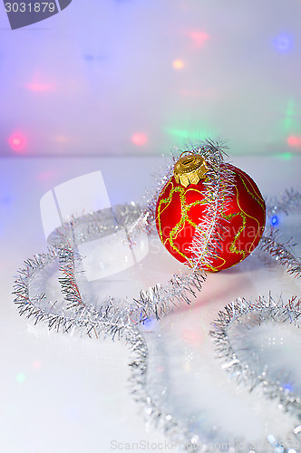 Image of Red Christmas-tree ball and tinsel