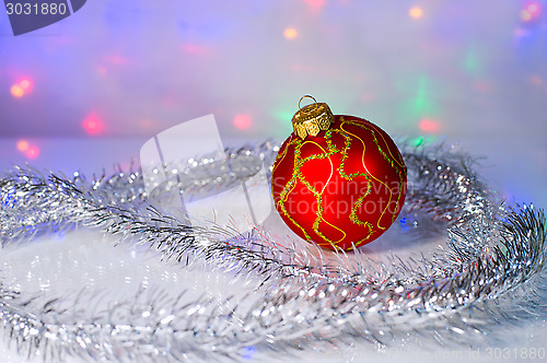 Image of Red Christmas-tree ball and tinsel