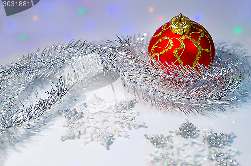 Image of Christmas ball, tinsel and snowflakes