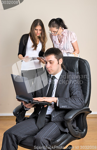 Image of Businessman with laptop works in office