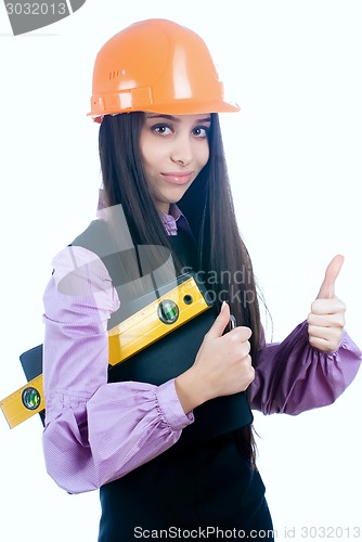 Image of Attractive girl with level shows thumb up gesture
