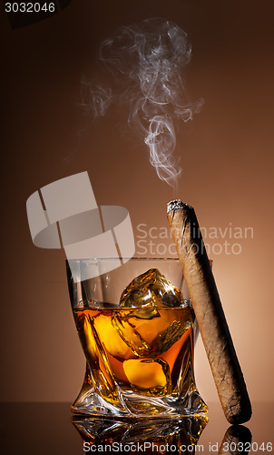 Image of Glass of whiskey and cigar