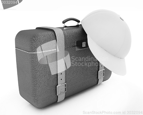 Image of Brown traveler's suitcase and peaked cap 