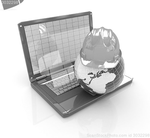Image of Hard hat and earth on a laptop 