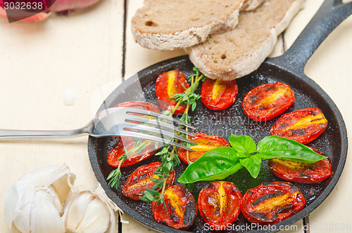 Image of baked cherry tomatoes with basil and thyme