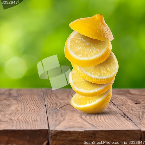 Image of Fresh lemon cuts on wooden table