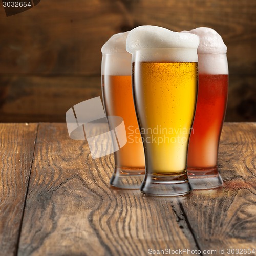 Image of Different beer in glasses on wood