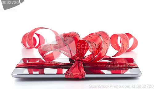 Image of tablet pc with christmas decorations on white background