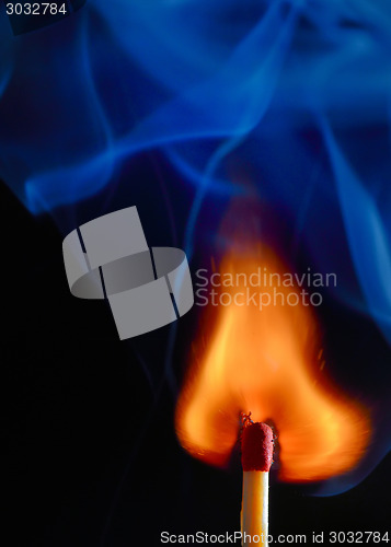 Image of Burning match with blue smoke 