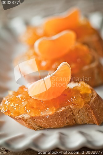 Image of pieces of baguette with orange marmalade