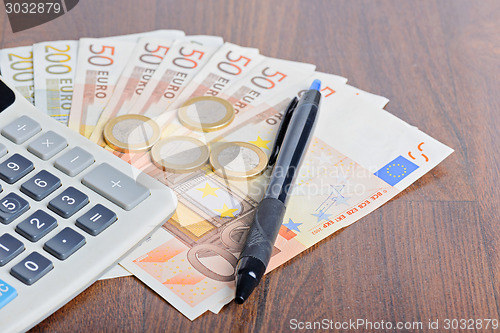Image of Calculator and money on the table