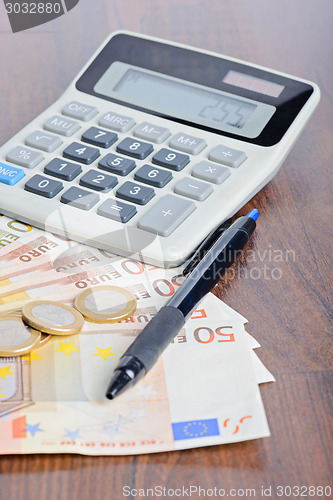 Image of Calculator and money on the table