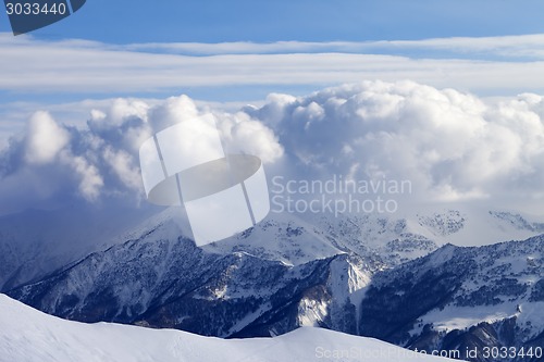 Image of Snowy mountains in clouds and off-piste slope