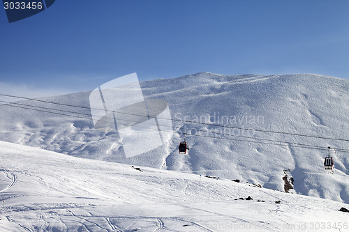 Image of Gondola lifts and ski slope at nice sun day