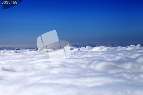 Image of Mountains under clouds in sun day