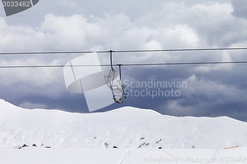 Image of Chair lifts and off-piste slope at gray day
