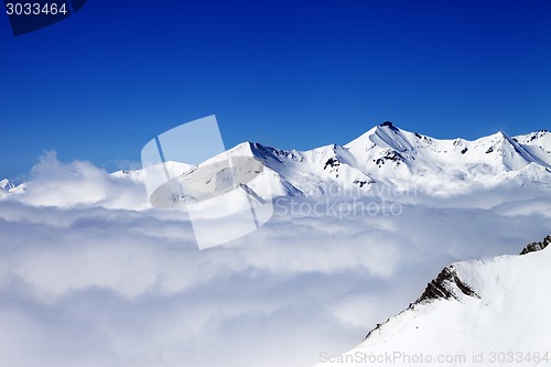 Image of Winter snowy mountains under clouds at nice day